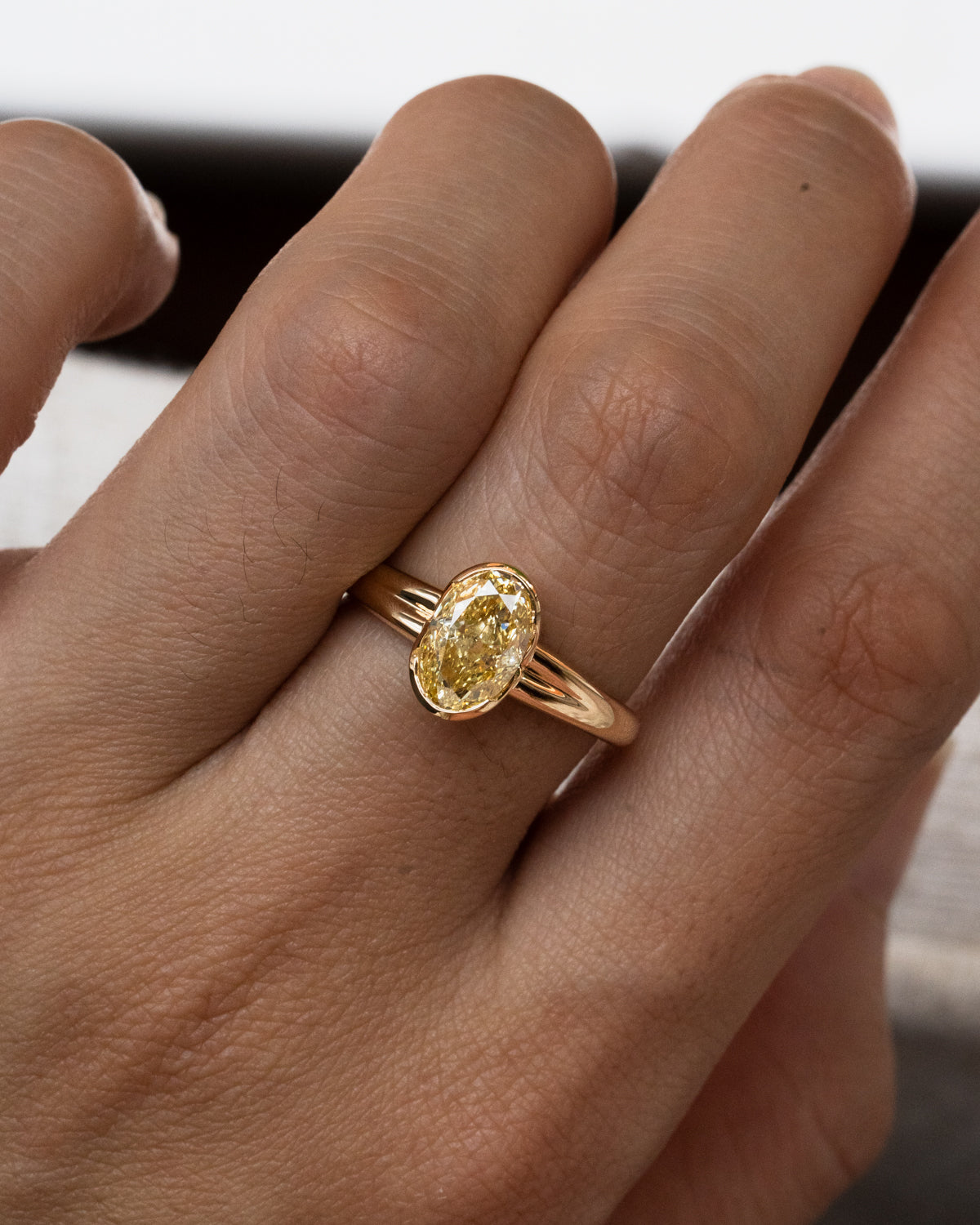 Oval yellow diamond with half bezel