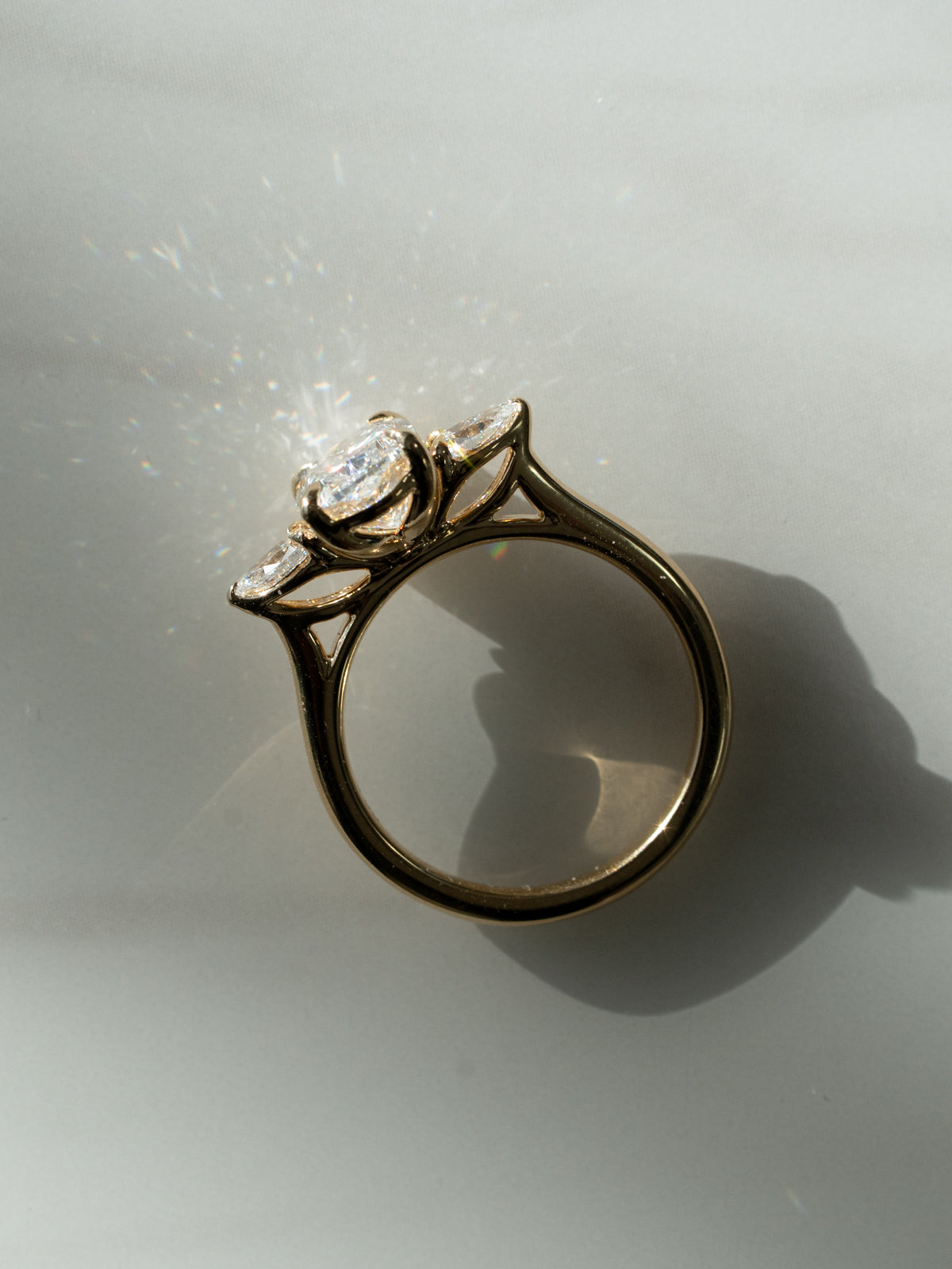 Custom elongated cushion cut diamond engagement ring with natural pear side stones in 18k yellow gold trilogy setting with floral basket and eagle prongs - bespoke engagement ring