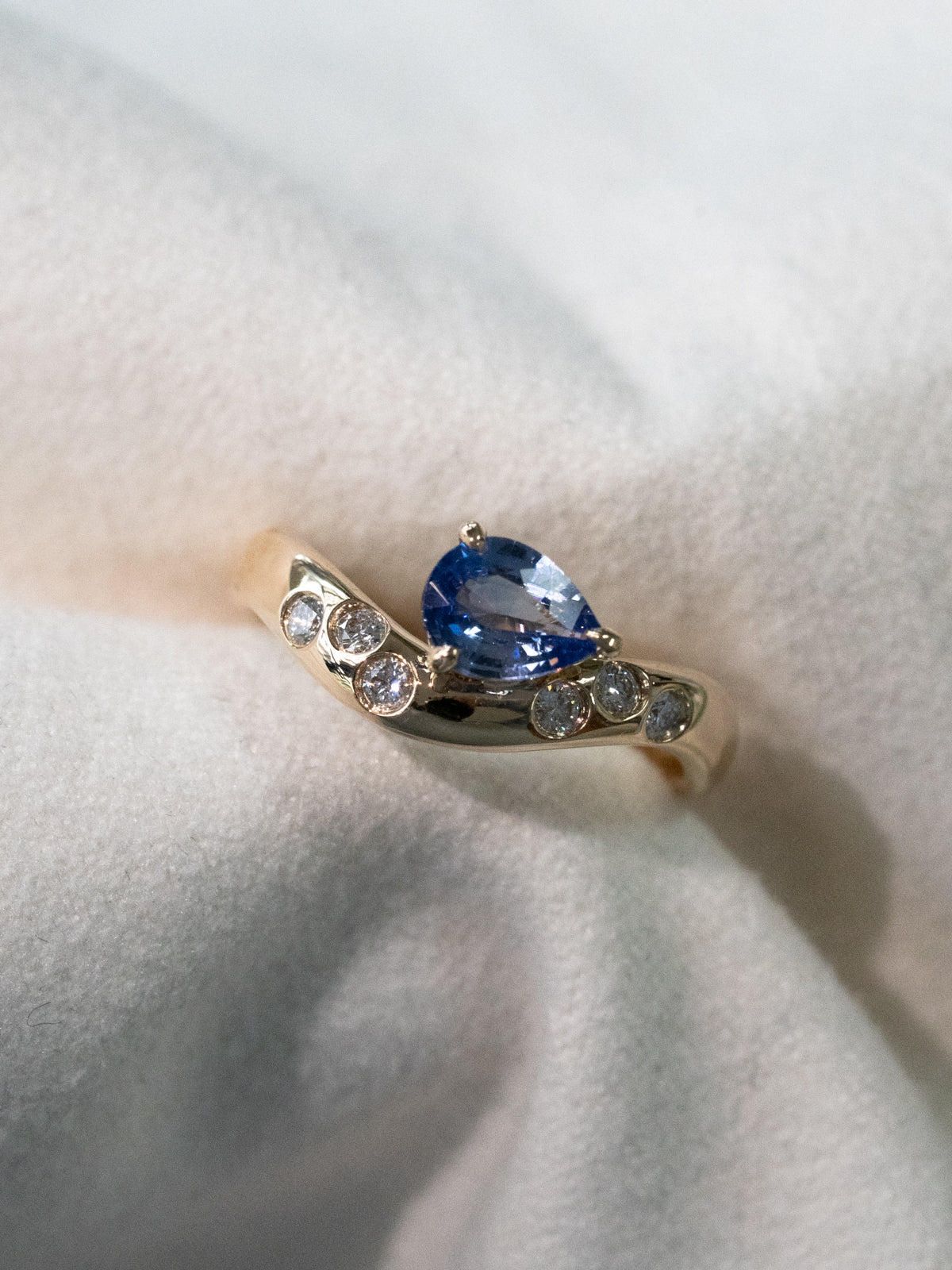 Blue Sapphire Wave Ring with Scattered Diamonds