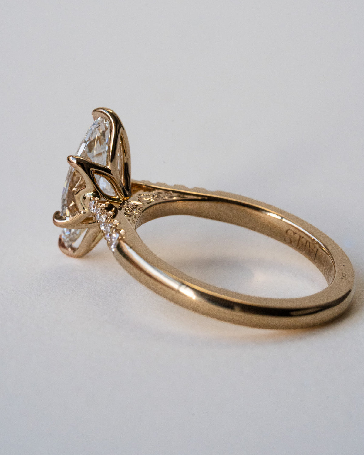 Marquise diamond with pavé shoulders and floral engraving