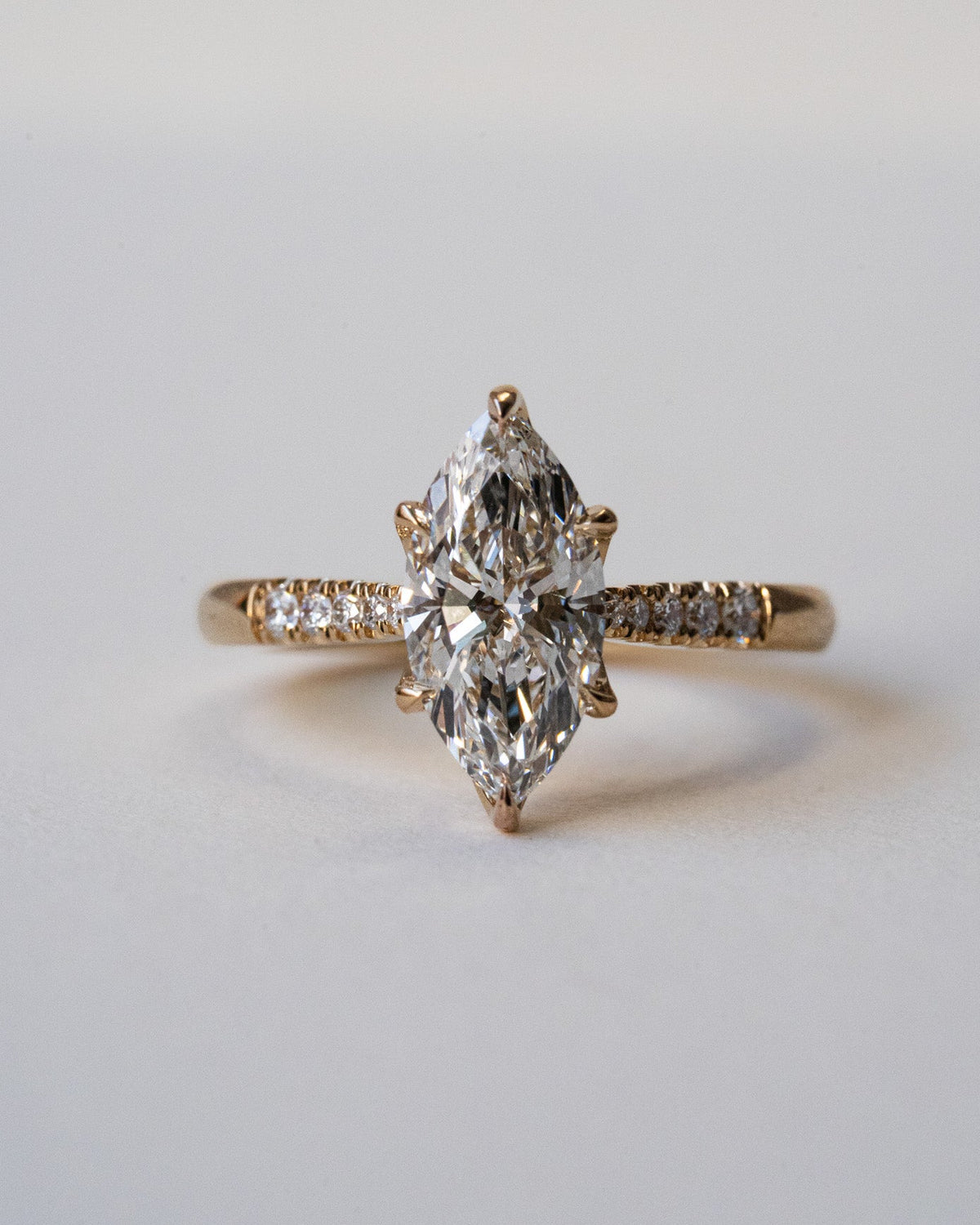 Marquise diamond with pavé shoulders and floral engraving