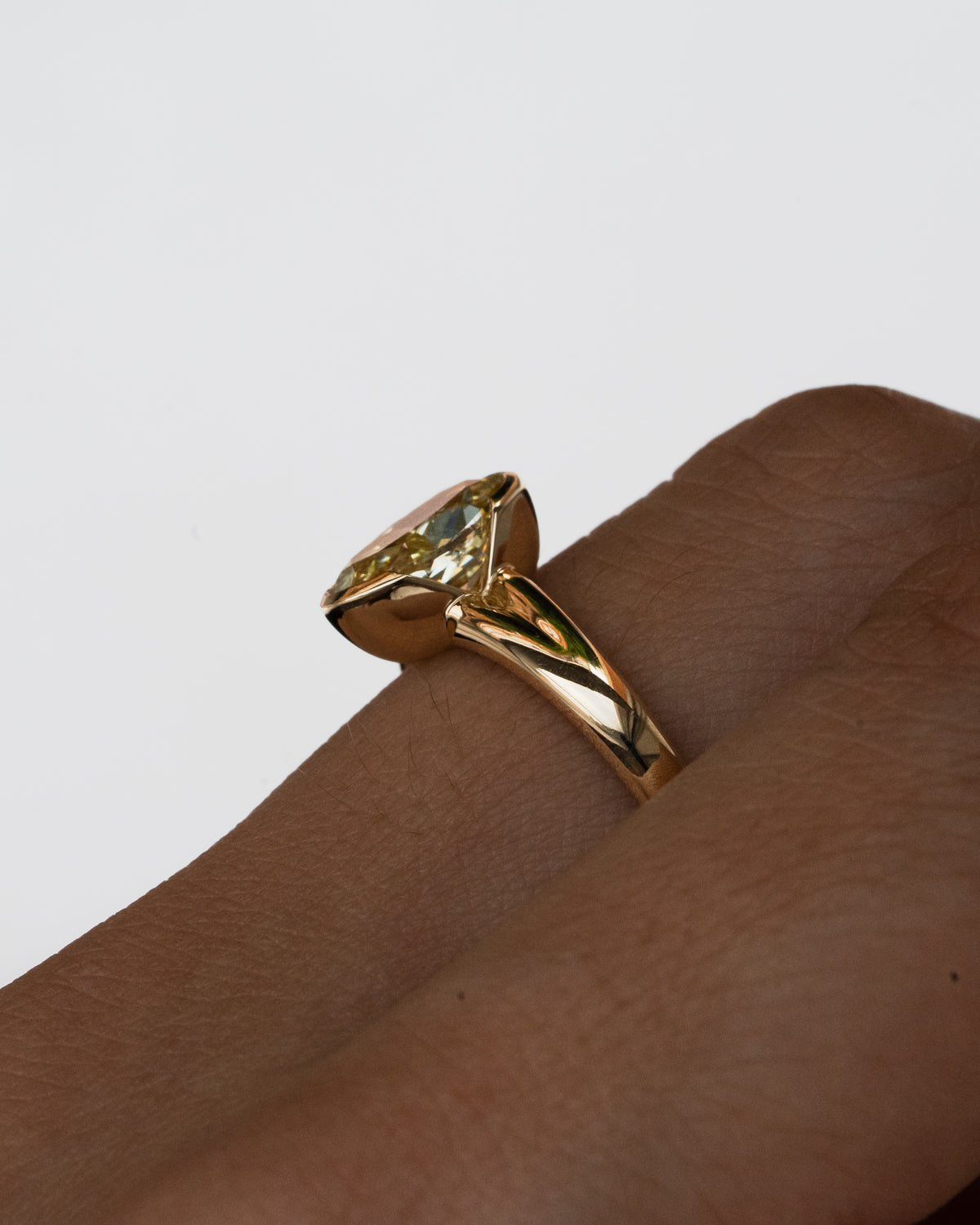 Oval yellow diamond with half bezel