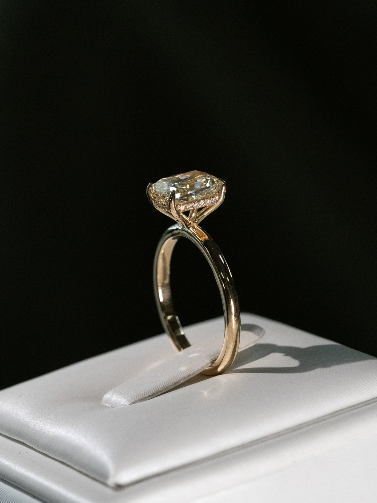 Fancy yellow elongated cushion cut diamond solitaire engagement ring with hidden halo in 18ct yellow gold - custom engagement ring side view